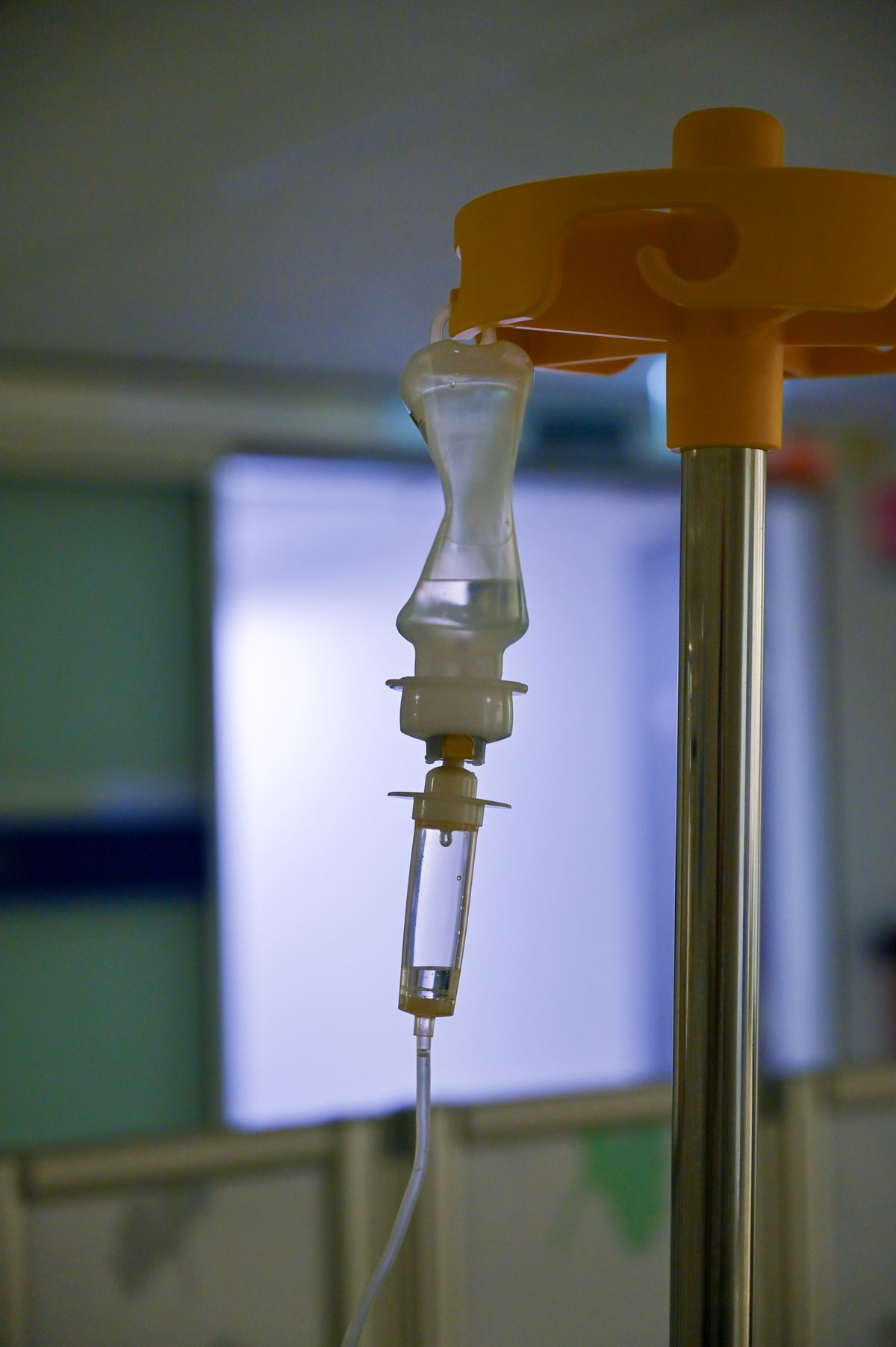 An intravenous drip bag and drip chamber hanging from a stand